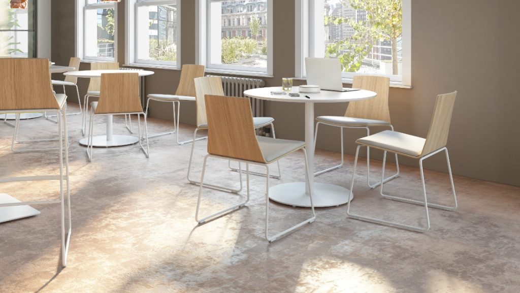 Round dining tables and wooden chairs in office cafe space