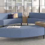 Blue round office sectional couch with white rug