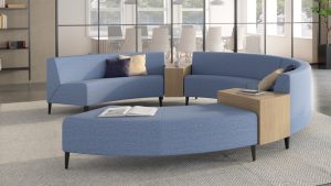 Blue round office sectional couch with white rug