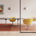 SW_1 Conference Table surrounded by four yellow chairs inside an office.