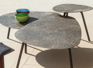 Hammered aluminum outdoor tables of various sizes grouped together