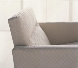 White plush armchair with geometric pattern on fabric
