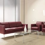 Matching red leather sofa and armchairs with glass coffee table