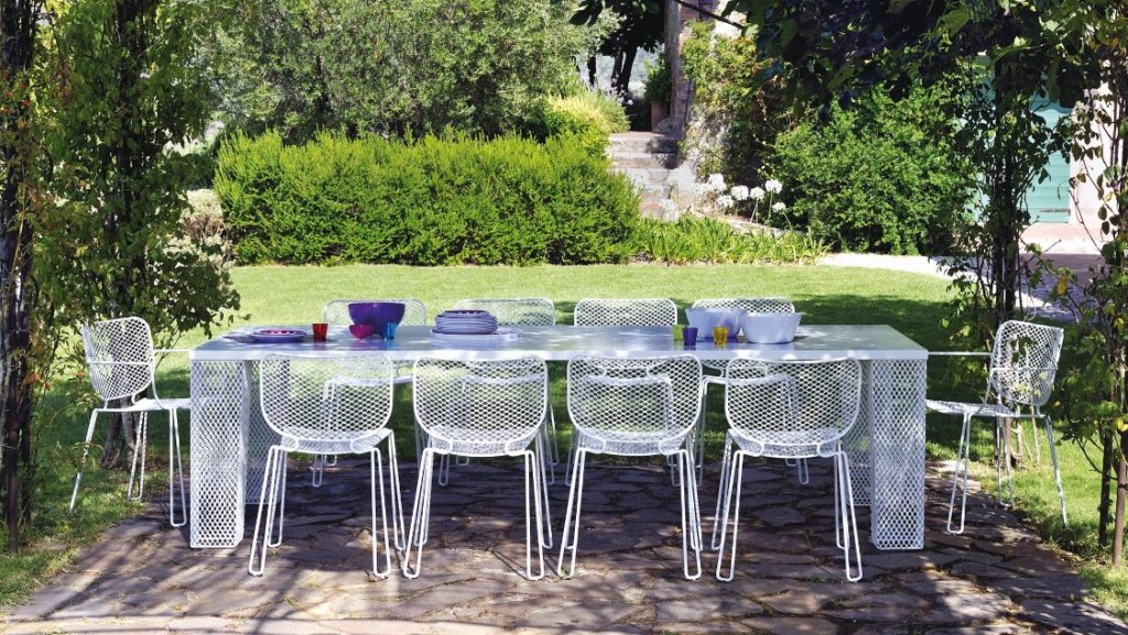 White wire outdoor furniture set with long white picnic table and matching outdoor side chairs