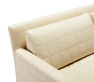White leather upholstery on couch with thick cross-stitching