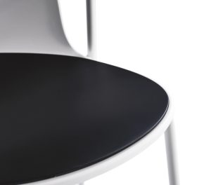 Close-up corner of office side chair with white material and black upholstered cushion