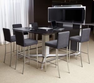 Office stools with grey upholstery and cushioned back placed near wooden meeting table