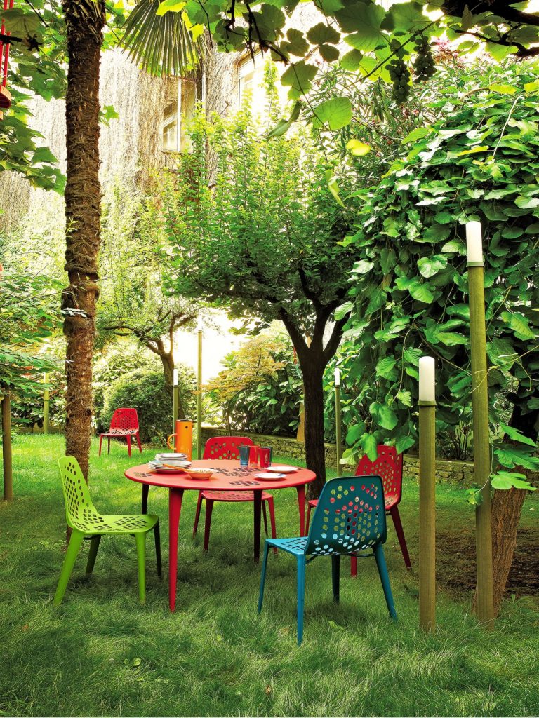 Outdoor gathering area with colorful outdoor tables and chairs