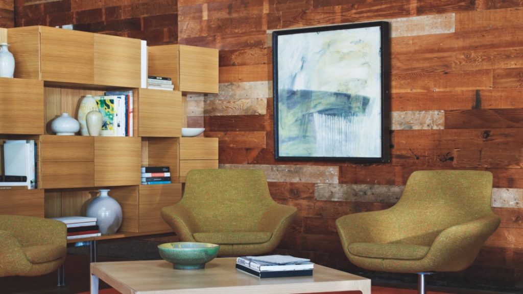 Wooden cube credenza in room with office lounge armchairs and wooden table