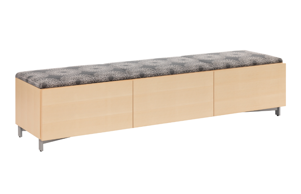 Long wooden bench with patterned fabric cushions on top and short aluminum base