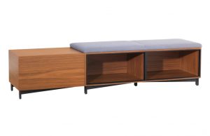 Exponents Bench in wood finish with two upholstered seats and open shelving for storage underneath