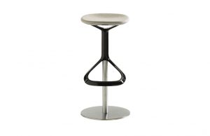 Lox office stool with beige upholstered seat, black metal footrest, and brushed metal post