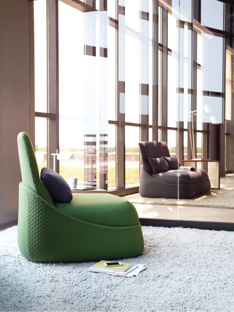 Tall plush lounge chairs in office private space with plush rugs