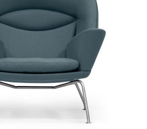 Blue rounded-back office armchair with winged armrests and metal base