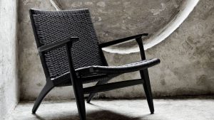 Black handmade outdoor chair with woven back and seat