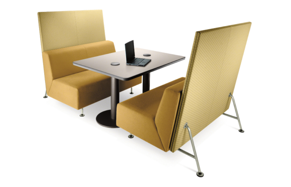 Yellow office couches with matching privacy screens around a metal table with laptop