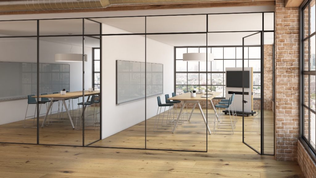 Glass walls leading into office meeting rooms with long tables, wall-mounted whiteboards, and mobile meeting room boards