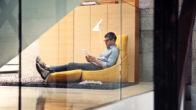 Office worker using tablet on yellow Hosu convertible lounge chair