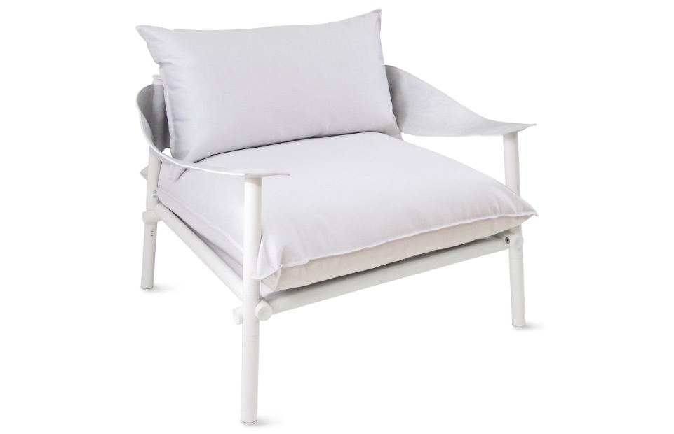 Low-backed plush outdoor chair with white upholstery and matching white frame