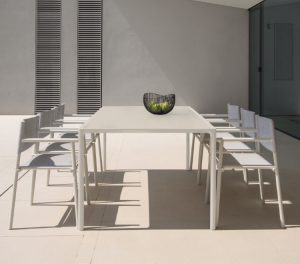Outdoor office dining space with fabric-backed outdoor chairs and tall outdoor dining table