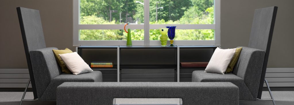 Office lounge space with bench seating, privacy screens, and storage cabinet