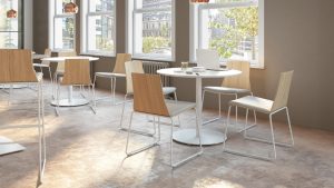 Round dining tables and wooden chairs in office cafe space