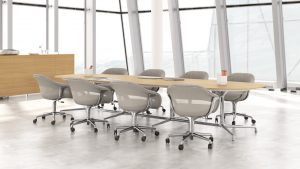 White office meeting room with oblong wooden meeting table and matching grey mobile conference chairs