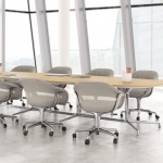 White office meeting room with oblong wooden meeting table and matching grey mobile conference chairs