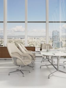 Light grey meeting chairs around white office conference table with wooden storage credenza