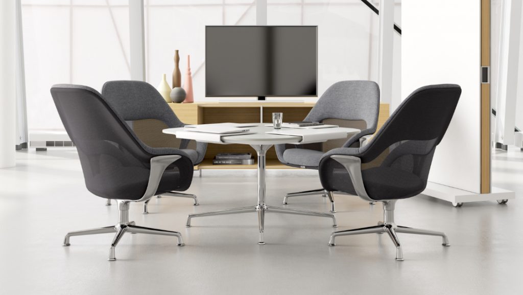Grey fabric office chairs around round table with adjacent TV stand