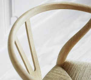 Wooden wishbone back and wicker seat of office side chair