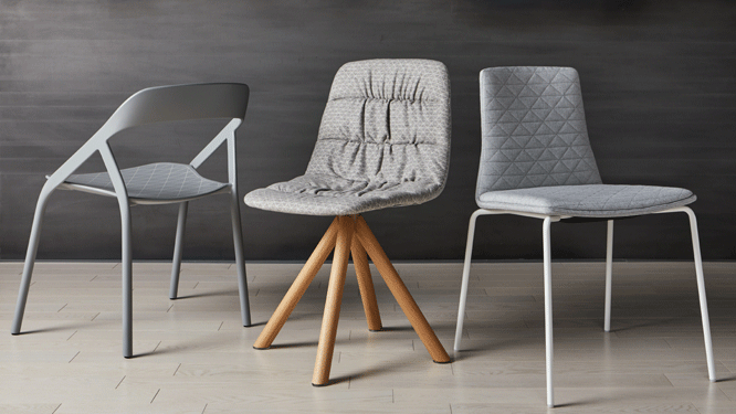 Three different office chairs, one grey made with carbon fiber, one with wooden legs and grey fabric and one grey diamond fabric with grey metal legs.