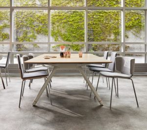 Grey side chairs and wooden coffee table in office social space