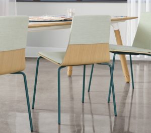 Wooden office meeting chairs with green upholstery around long wooden office conference table
