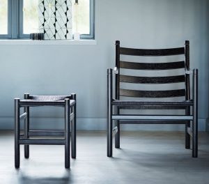 Black wooden outdoor chair with matching wooden stool