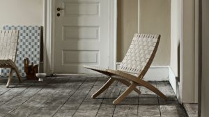 Wooden outdoor lounge chair with interwoven beige wooden strips for back and seat