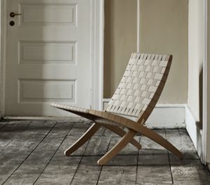 Wooden outdoor lounge chair with interwoven beige wooden strips for back and seat