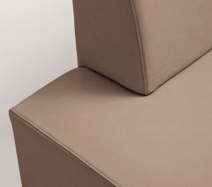 Corner of a beige leather office lounge sofa