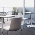 open space with three tables and 5 Enea lottus chairs in white color around