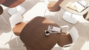 Wooden office lounge tables with rounded edges and matching white side chairs