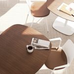 Wooden office lounge tables with rounded edges and matching white side chairs