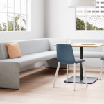 White Together Bench next to a small square table surrounded by two blue chairs.