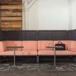 Two grey Lagunitas Personal Table in front of a large pink sofa.