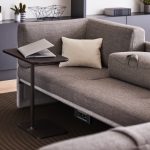 Black Lagunitas Personal Table next to a grey sofa.