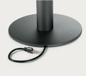 Base of tall office lamp with metal stand and power cable