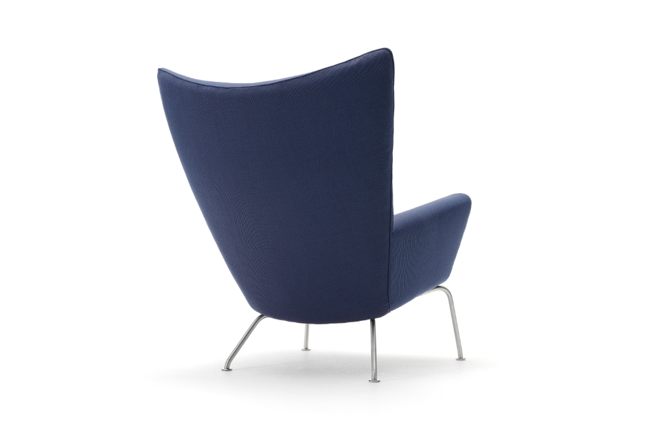 Blue upholstered wingback chair with low armrest and aluminum legs