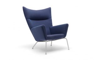 High-backed wing style office lounge chair with high armrests, blue upholstery, and metal legs