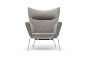 High-backed lounge chair with high armrests, rounded back, grey upholstery, and aluminum legs