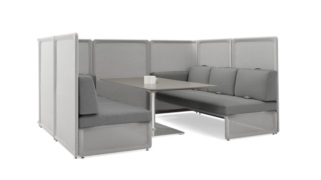 Modular lounge seating arrangement with high privacy panels, gray benches, and a central square table