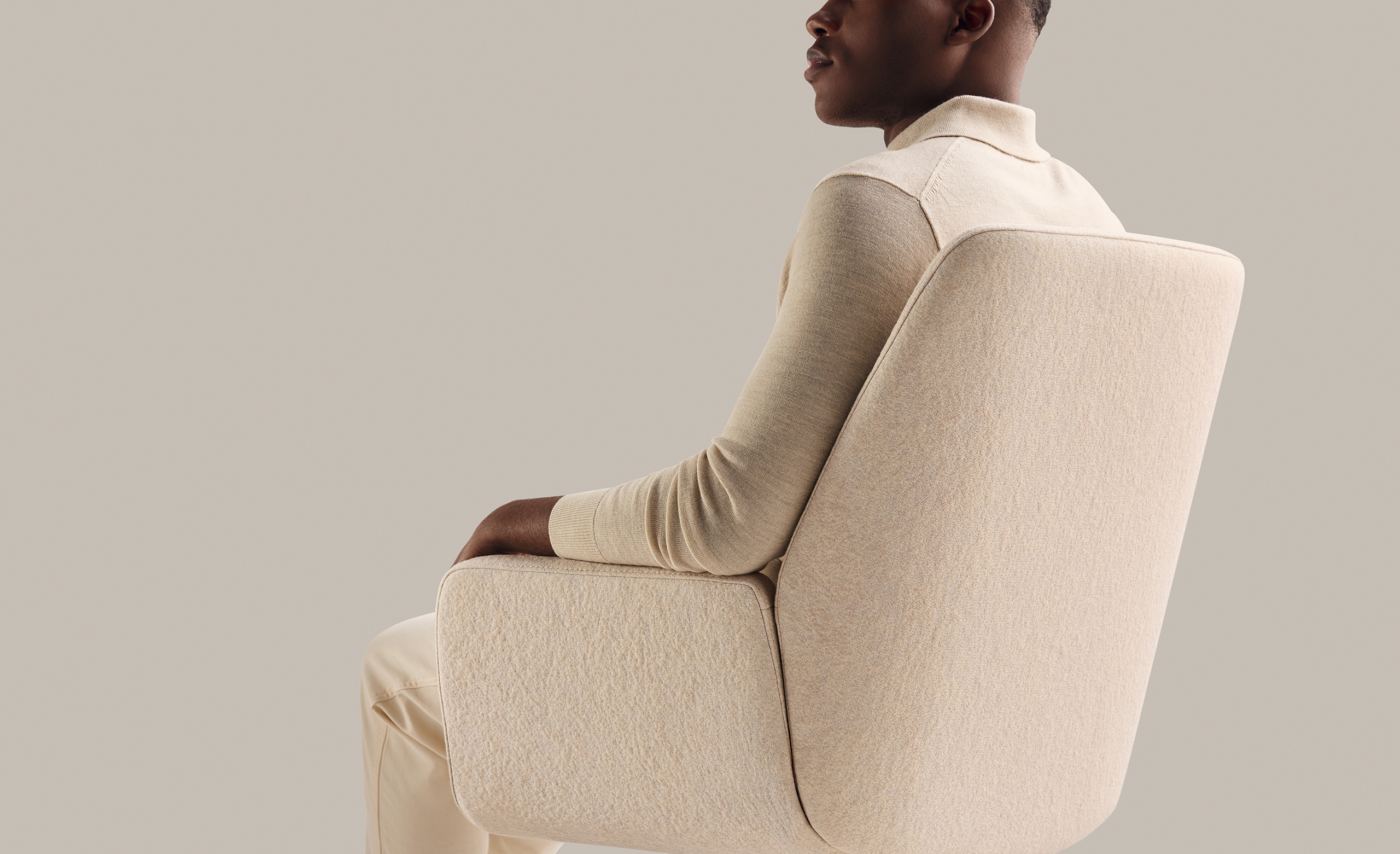 Man sitting in a bone-colored Bindu Conference Chair with his back to the camera